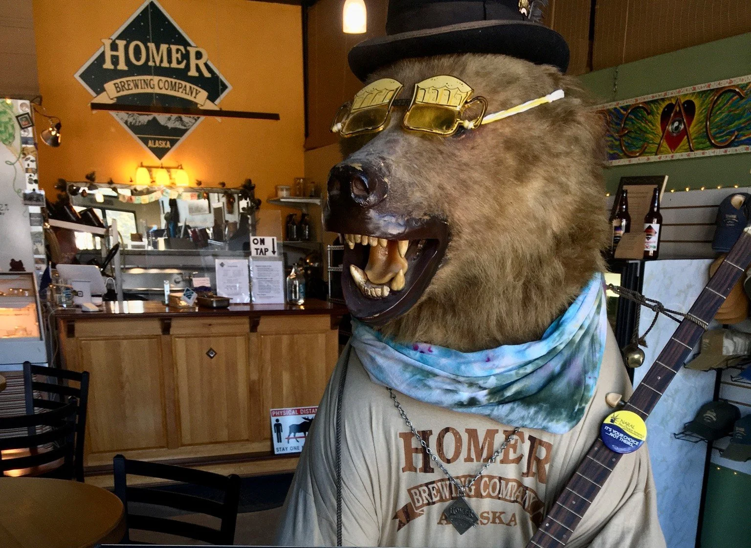 Inside the Homer Brewing taproom with the brewery's bear mascot display