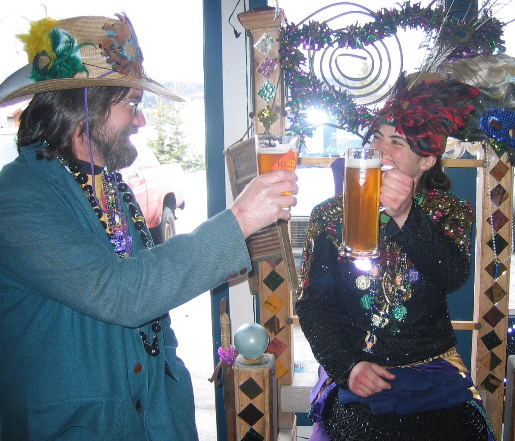 Two people raising Homer Brewing beers inside the brewery